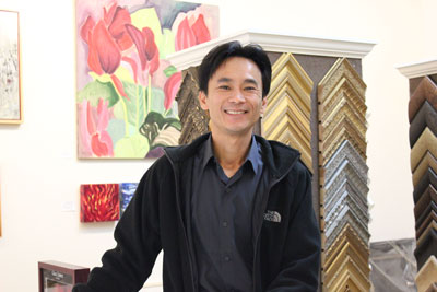 Khanh Tran in his Frame by Frame gallery in the Dow Building on University Avenue. (Photo by Kristal Leebrick)