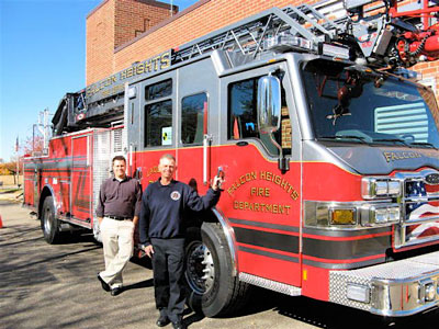 Bart Fischer, Falcon Heights city administrator, left, and Michael Poeschl, fire chief, show off the city’s new ladder truck. Photo by Roger Bergerson