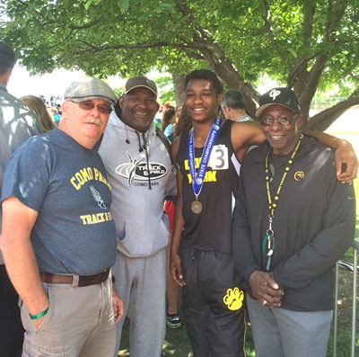 Trevon Clay with track coaches Roy Magnuson (left), John Robinson and Marv Rouse (right)
