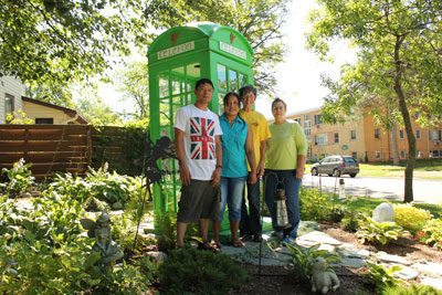 Above right, Carol Mulroy (second from right) and her neighbors pose with the Irish “telefon” booth in her front yard in St. Anthony Park. With her are Ram and Devi Rana (left) and Jeanne St. Clair (far right), all of whom helped her with the project. Photos by Kristal Leebrick