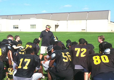 Coach Kirby Scull addresses his football players at the end of practice on Sept. 3. Scull has been serving as Como’s head football coach for the past 12 years.