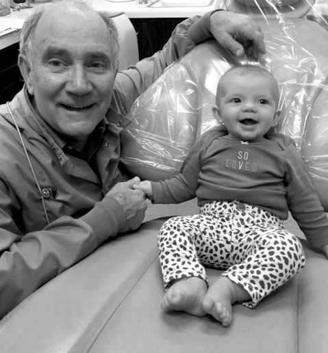 Dr. Frank Steen poses with fourth-generation patient, Eliana, whose parents, grandparents and great-grandparents were patients at his practice