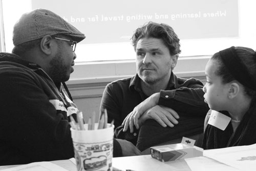 Ten-year-old Aja Holland (right), a student at Farnsworth Aerospace school, and her dad Bukwon Holland (left) talk with author Dave Eggers at the Mid-Continental Oceanographic Institute. Photo by Kristal Leebrick