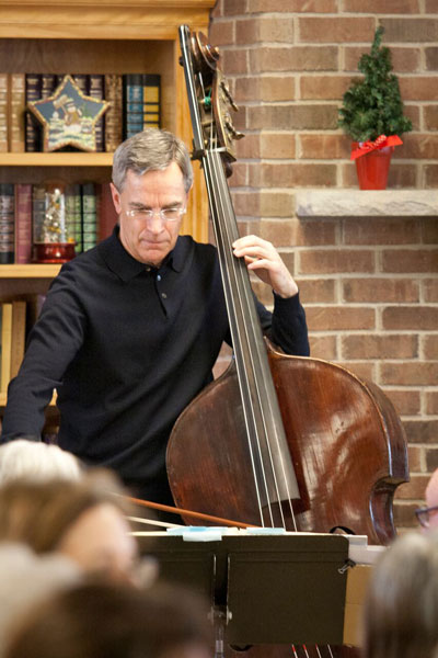 St. Anthony Park Home administrator John Barker plays bass at the Holiday Tea, as well as at various events throughout the year. Photo by Lori Hamilton