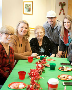 Mary Schifsky (center) and family members enjoy the holiday tea. Photo by Lori Hamilton
