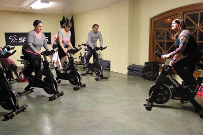 Meegan Hall of Como Park Yoga and Wellness takes a class through some spinning exercises. Photo by Kristal Leebrick