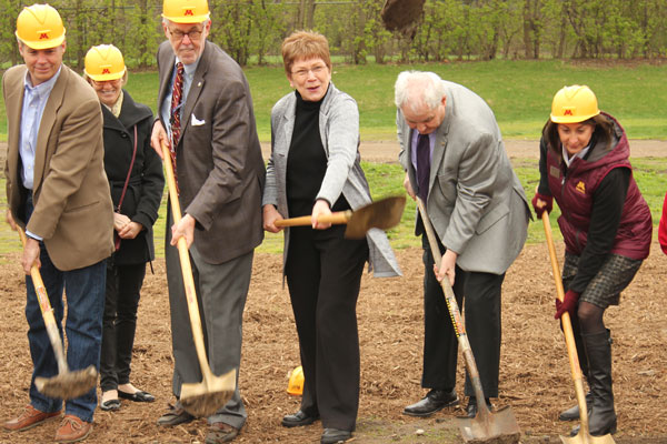 Rep. Alice Hausman throws a celebratory shovel of dirt into the air during the Earth Day groundbreaking of the Bell Museum. Photo by Kristal Leebrick