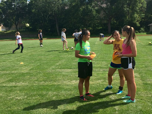Como girls’ soccer captains Tu Lor Eh Paw, Marie Wulff and Emily Forstrom discuss plans for a captains’ practice in early August. High school coaches and players officially kicked off the fall season on Aug. 15. 