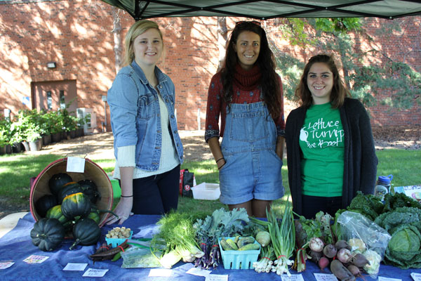 Students from a variety of disciplines work on the farm. Shown here at the farm’s produce stand are Kalley Guerdet, a senior in Environmental Science Policy and Management; Angie Tomlinson, a senior in Food Systems; and Jorie Shapiro, a senior Nutrition manager. 