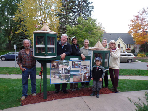 Alden Square neighbors show off their group project: two new Little Free Libraries.